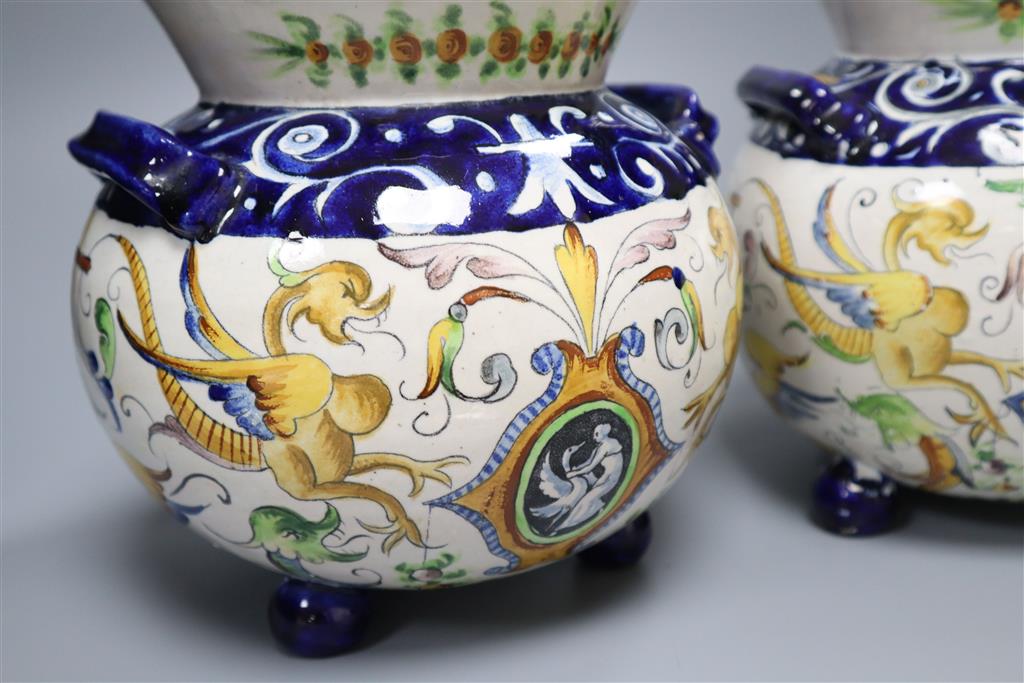 A pair of Urbino style Delft bulbous-bodied two-handled vases, each on three feet, height 18cm